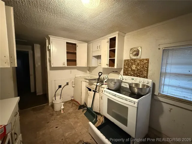 a kitchen with a stove and a sink