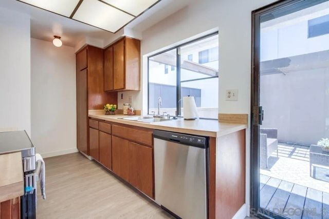 a kitchen with cabinets a sink and chairs