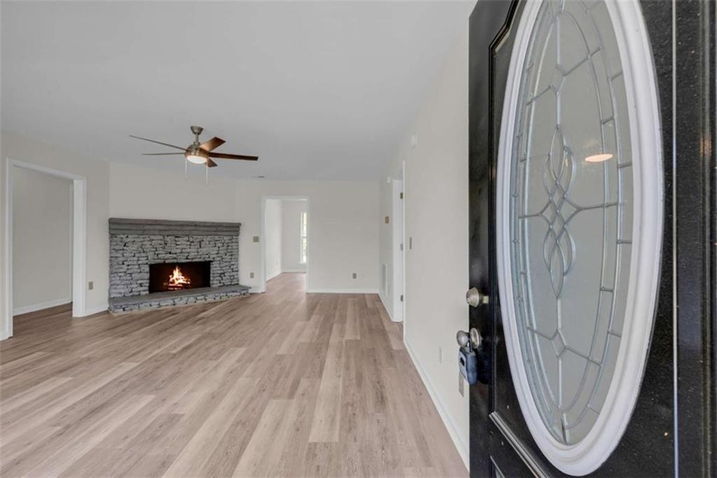 253 Sanders Old Farm Road Crawford, GA 30630 - Photo 12 of 34 a view of a livingroom with wooden floor and a fireplace
