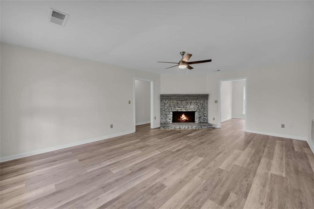 253 Sanders Old Farm Road Crawford, GA 30630 - Photo 13 of 34 a view of empty room with wooden floor and fireplace