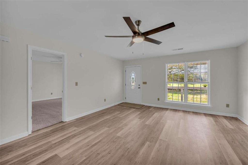 253 Sanders Old Farm Road Crawford, GA 30630 - Photo 15 of 34 a view of empty room with wooden floor and fan