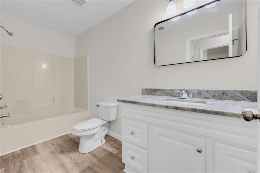 253 Sanders Old Farm Road Crawford, GA 30630 - Photo 20 of 34 a bathroom with a granite countertop toilet sink and mirror