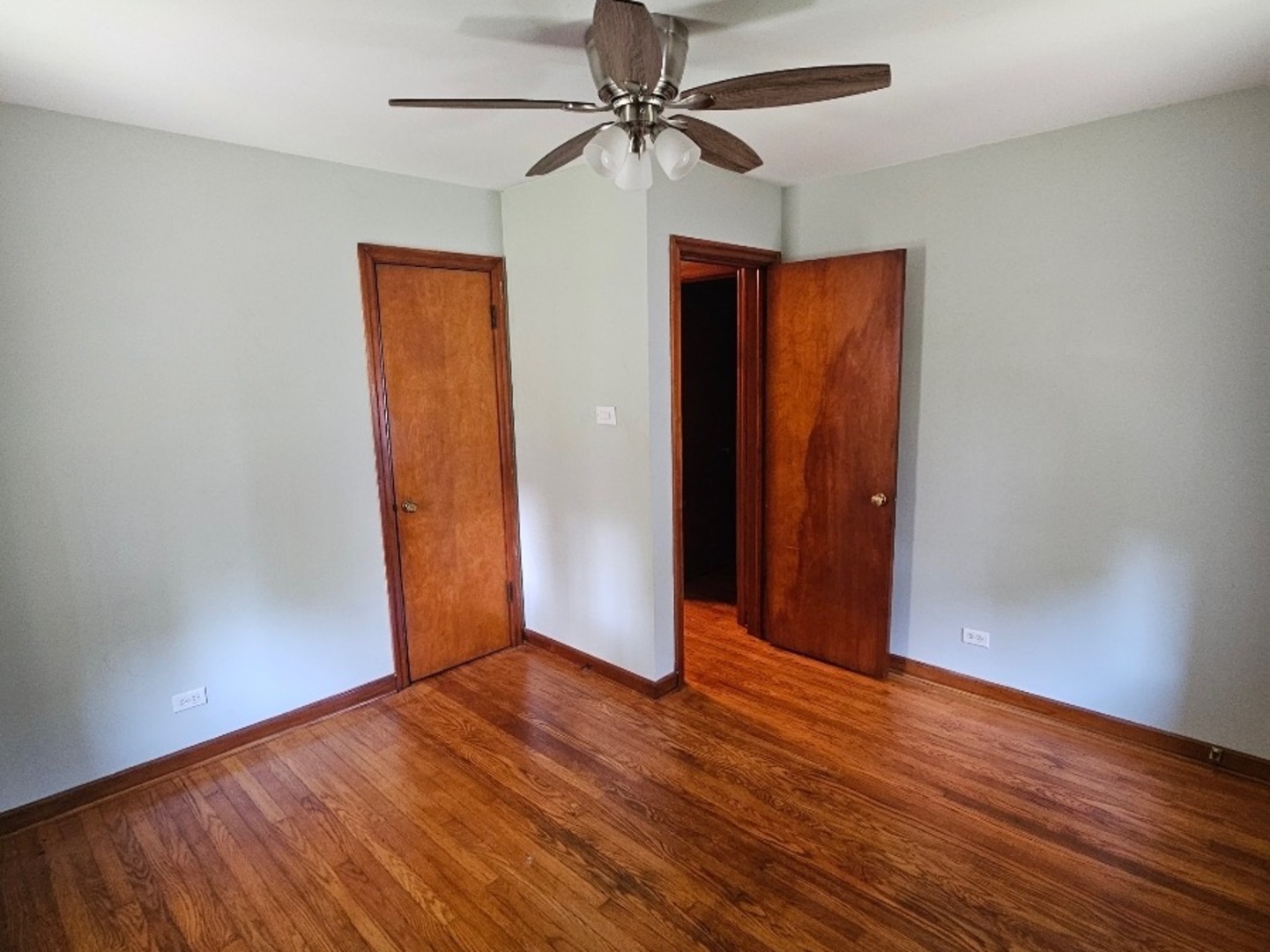1506 Main Street Crete, IL 60417 - Photo 16 of 17 an empty room with wooden floor and a ceiling fan