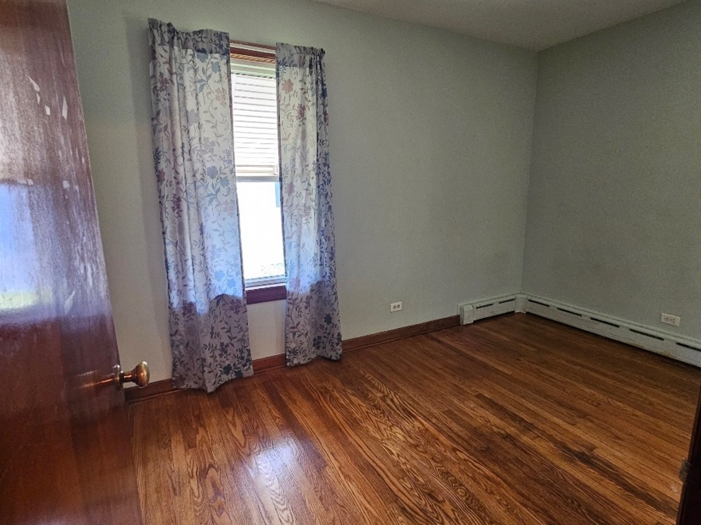 1506 Main Street Crete, IL 60417 - Photo 17 of 17 an empty room with wooden floor and windows