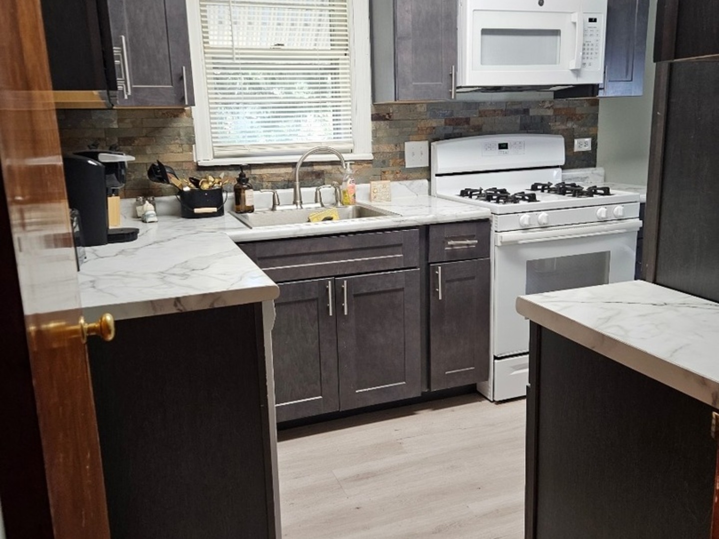 1506 Main Street Crete, IL 60417 - Photo 9 of 17 a kitchen with a sink stove and cabinets