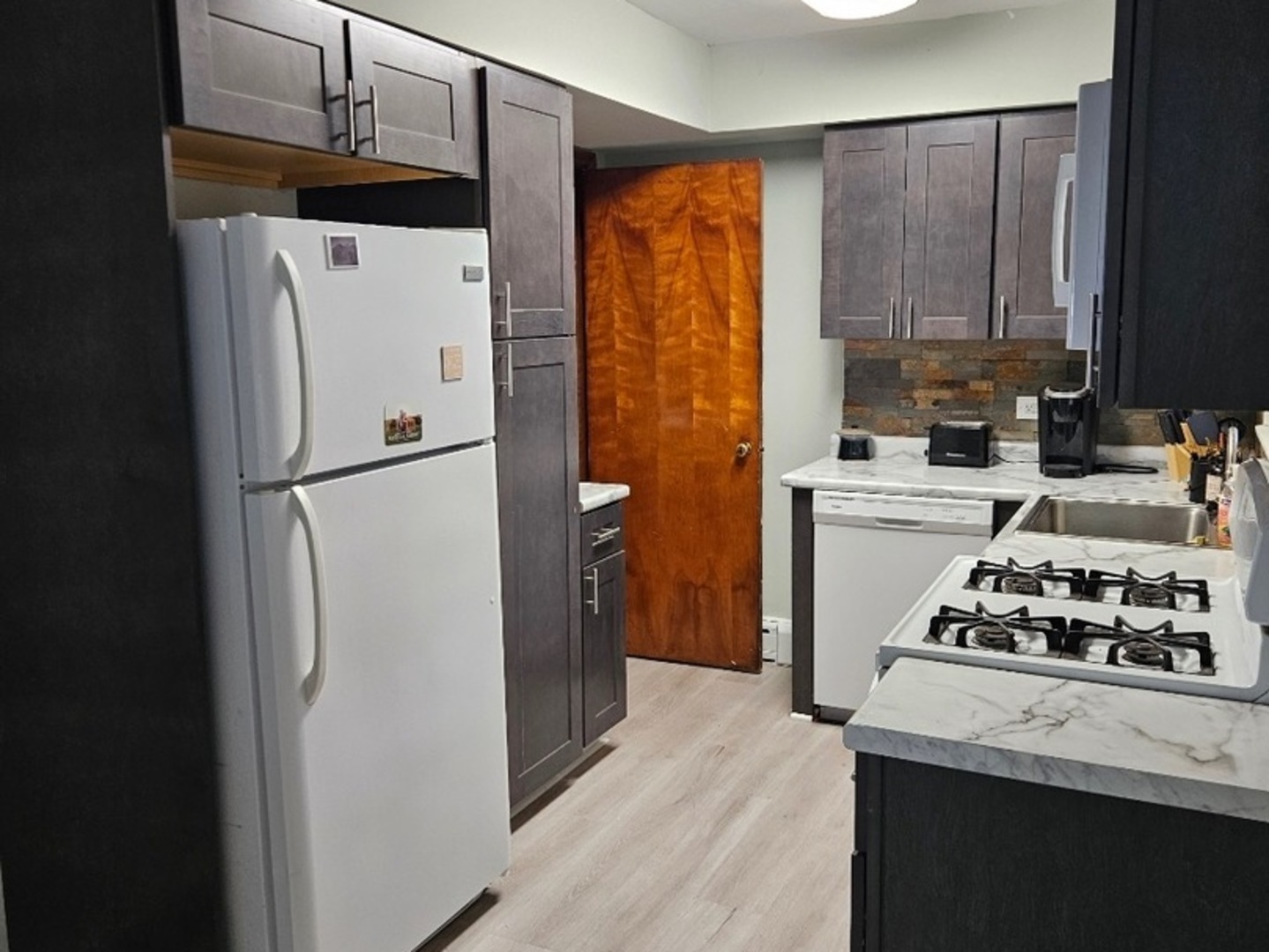 1506 Main Street Crete, IL 60417 - Photo 10 of 17 a kitchen with stainless steel appliances a refrigerator a stove a sink and cabinets