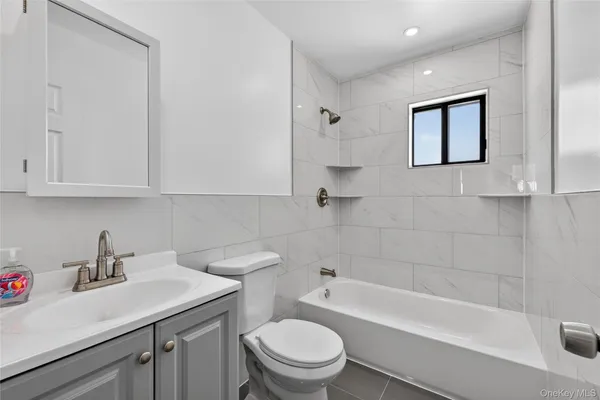 a bathroom with a sink a toilet and bathtub