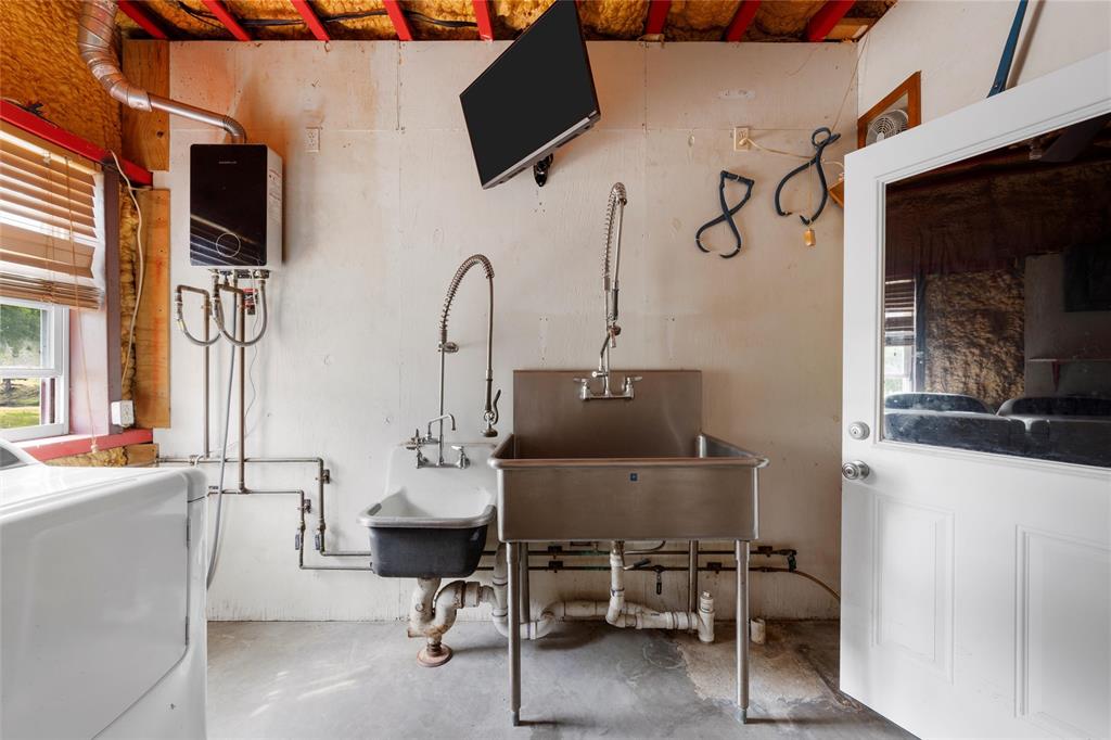 237 Lcr 711 Kosse, TX 76653 - Photo 13 of 40 Miscellaneous room featuring washer / dryer, concrete flooring, and a sink