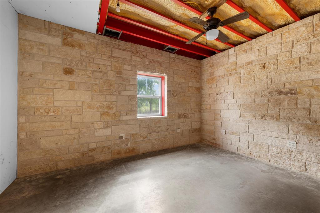 237 Lcr 711 Kosse, TX 76653 - Photo 14 of 40 Unfurnished room featuring a ceiling fan, visible vents, and concrete floors