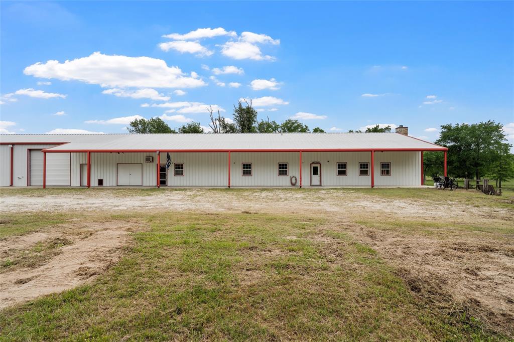 237 Lcr 711 Kosse, TX 76653 - Photo 2 of 40 View of front of home featuring a chimney, an outbuilding, an outdoor structure, and a garage