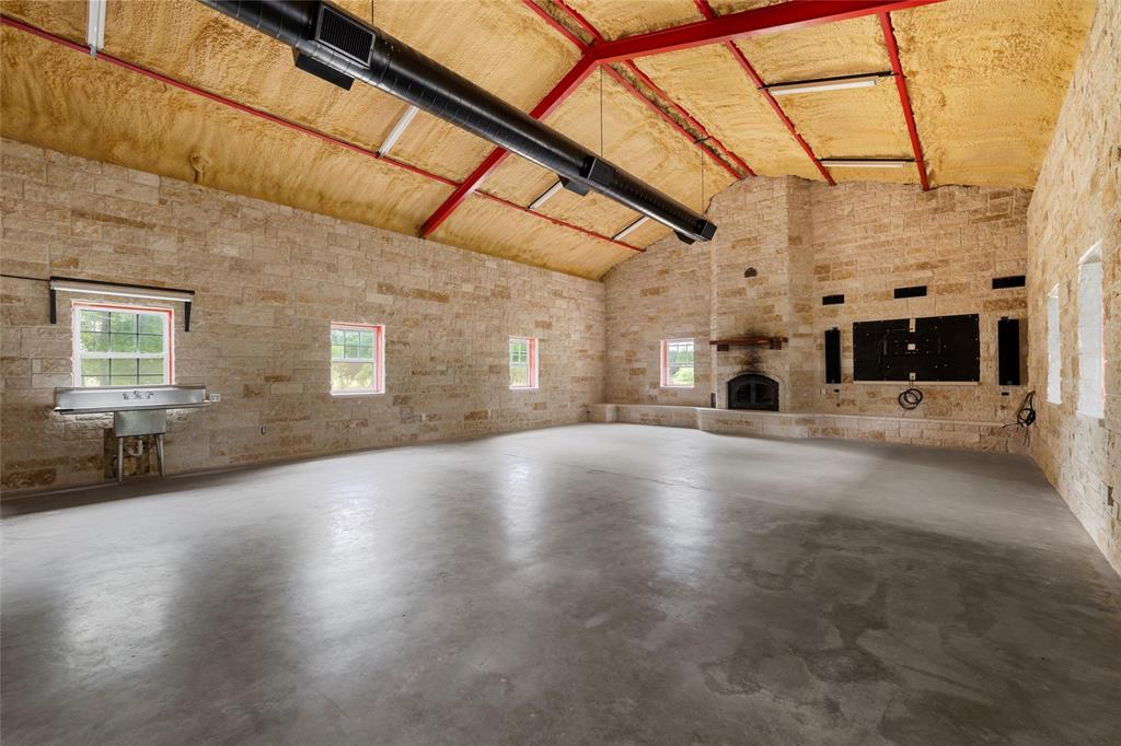 237 Lcr 711 Kosse, TX 76653 - Photo 21 of 40 Unfurnished living room featuring high vaulted ceiling and finished concrete floors