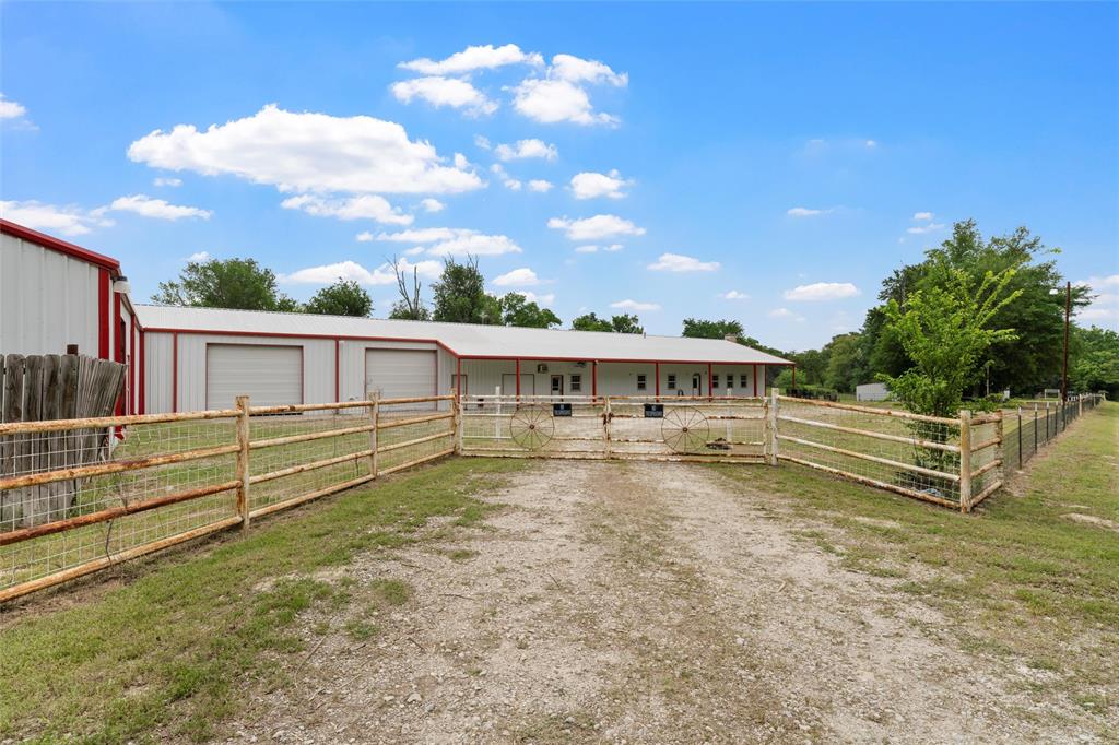 237 Lcr 711 Kosse, TX 76653 - Photo 30 of 40 View of front of house featuring driveway, an outdoor structure, and a detached garage