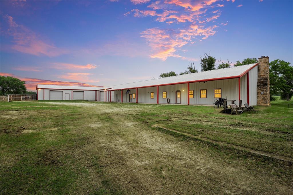 237 Lcr 711 Kosse, TX 76653 - Photo 4 of 40 Rear view of property with an outbuilding, a detached garage, and metal roof