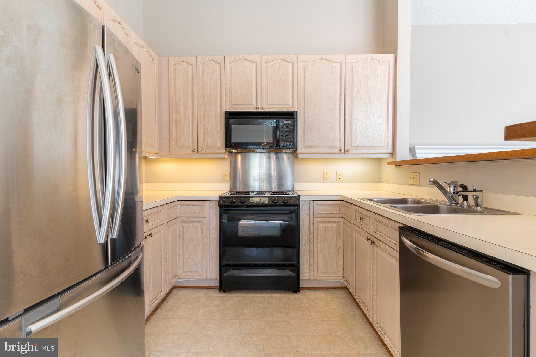 533 Runabout Loop, Unit 533 Solomons, MD 20688 - Photo 11 of 29 a kitchen with a refrigerator and a sink