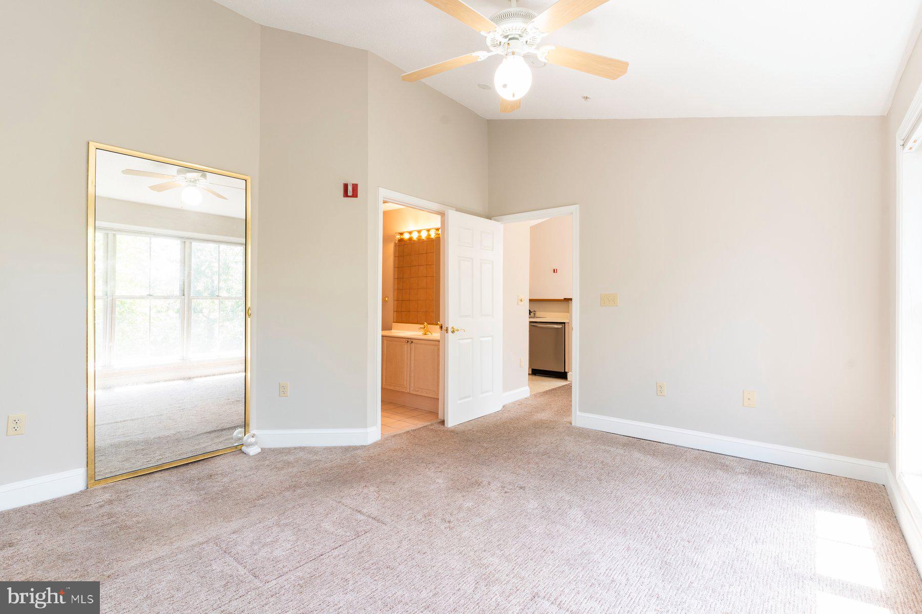 533 Runabout Loop, Unit 533 Solomons, MD 20688 - Photo 16 of 29 an empty room with closet and a chandelier fan