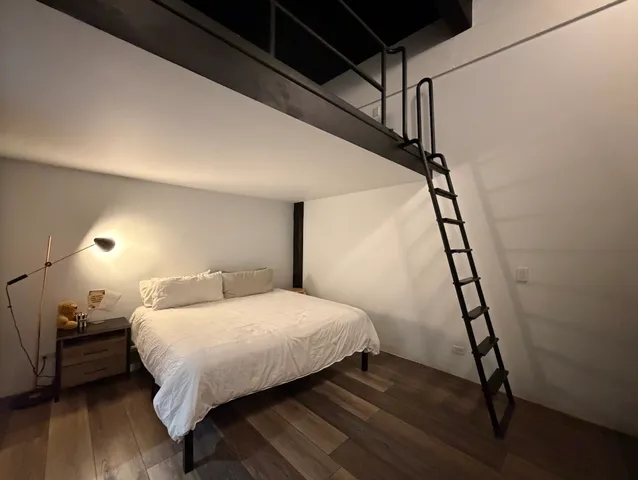a bedroom with a bed and a window