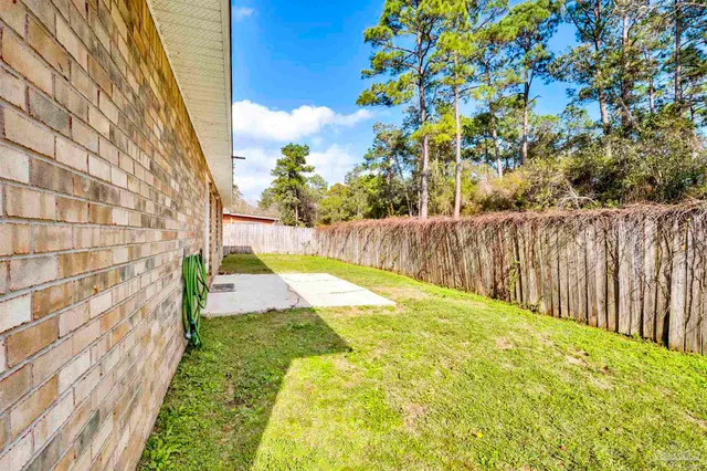 a view of swimming pool with wooden fence