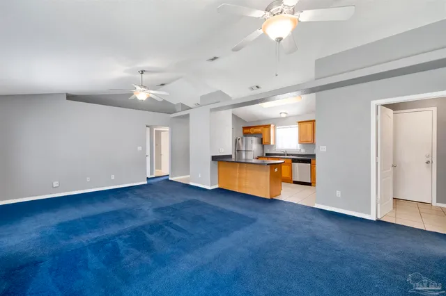 a view of kitchen with stove and cabinets