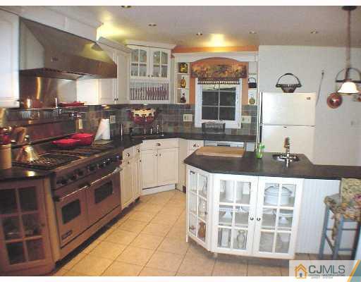 17 Simpson Road Somerset, NJ 08873 - Photo 3 of 8 a kitchen with stainless steel appliances granite countertop a stove and a sink