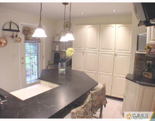 17 Simpson Road Somerset, NJ 08873 - Photo 4 of 8 a view of a kitchen with furniture and a chandelier