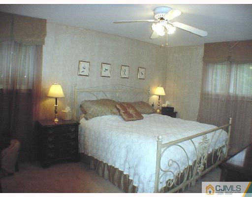 17 Simpson Road Somerset, NJ 08873 - Photo 7 of 8 a bedroom with a bed and a chandelier