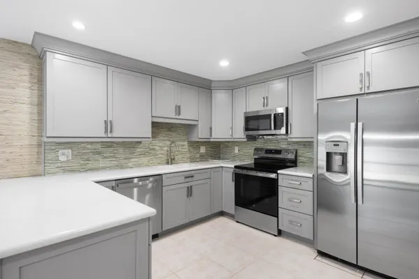 a kitchen with a sink stainless steel appliances and cabinets