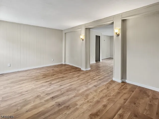 a view of an empty room and wooden floor