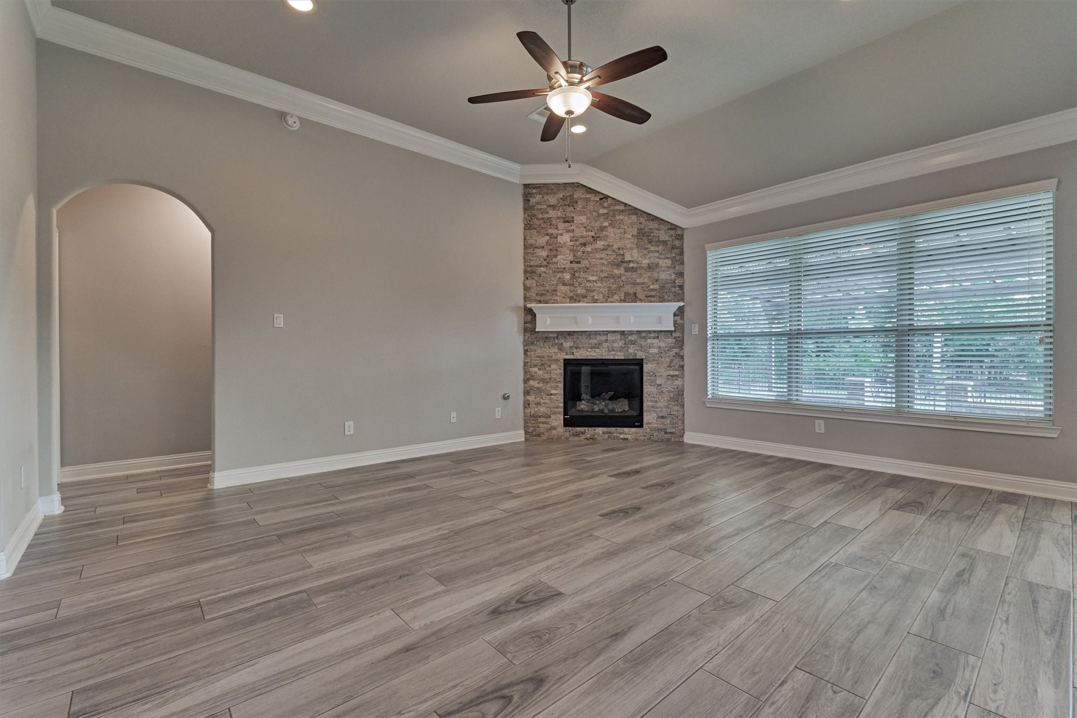 180 Racetrack Lane Montgomery, TX 77356 - Photo 12 of 46 Large living area has a stacked stone gas fireplace and views of Memory Park.