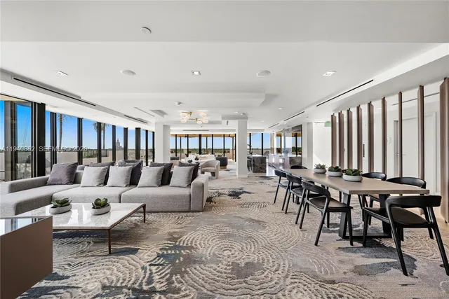 a view of a patio with table and chairs with wooden floor and fence