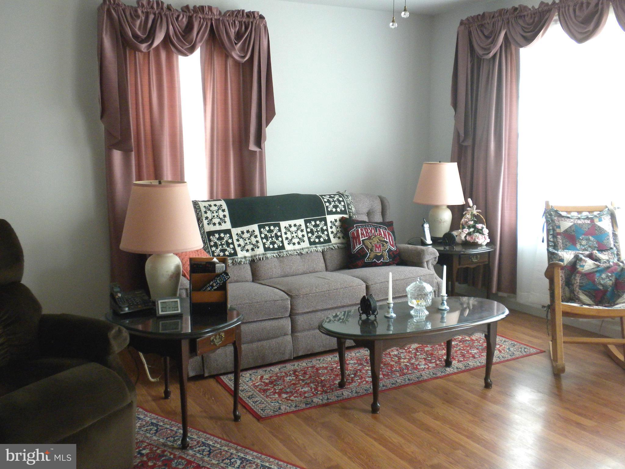 2114 Gaybrook Road Baltimore, MD 21244 - Photo 2 of 19 a living room with furniture and a lamp