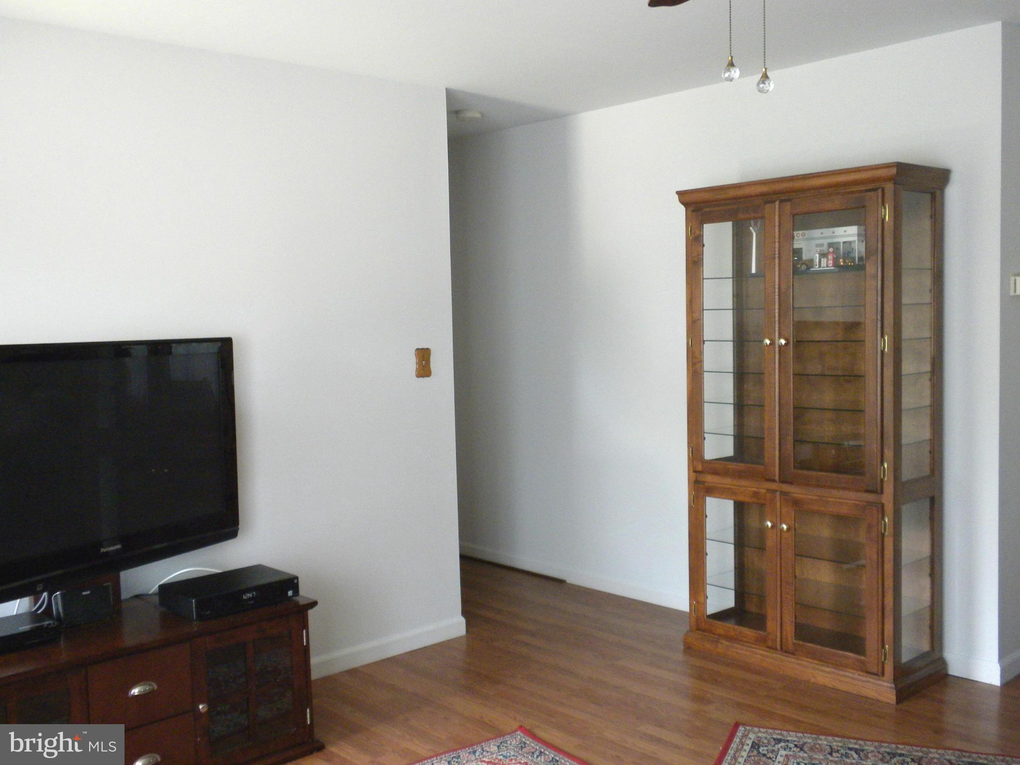 2114 Gaybrook Road Baltimore, MD 21244 - Photo 3 of 19 a view of a workspace with wooden floor and cabinet