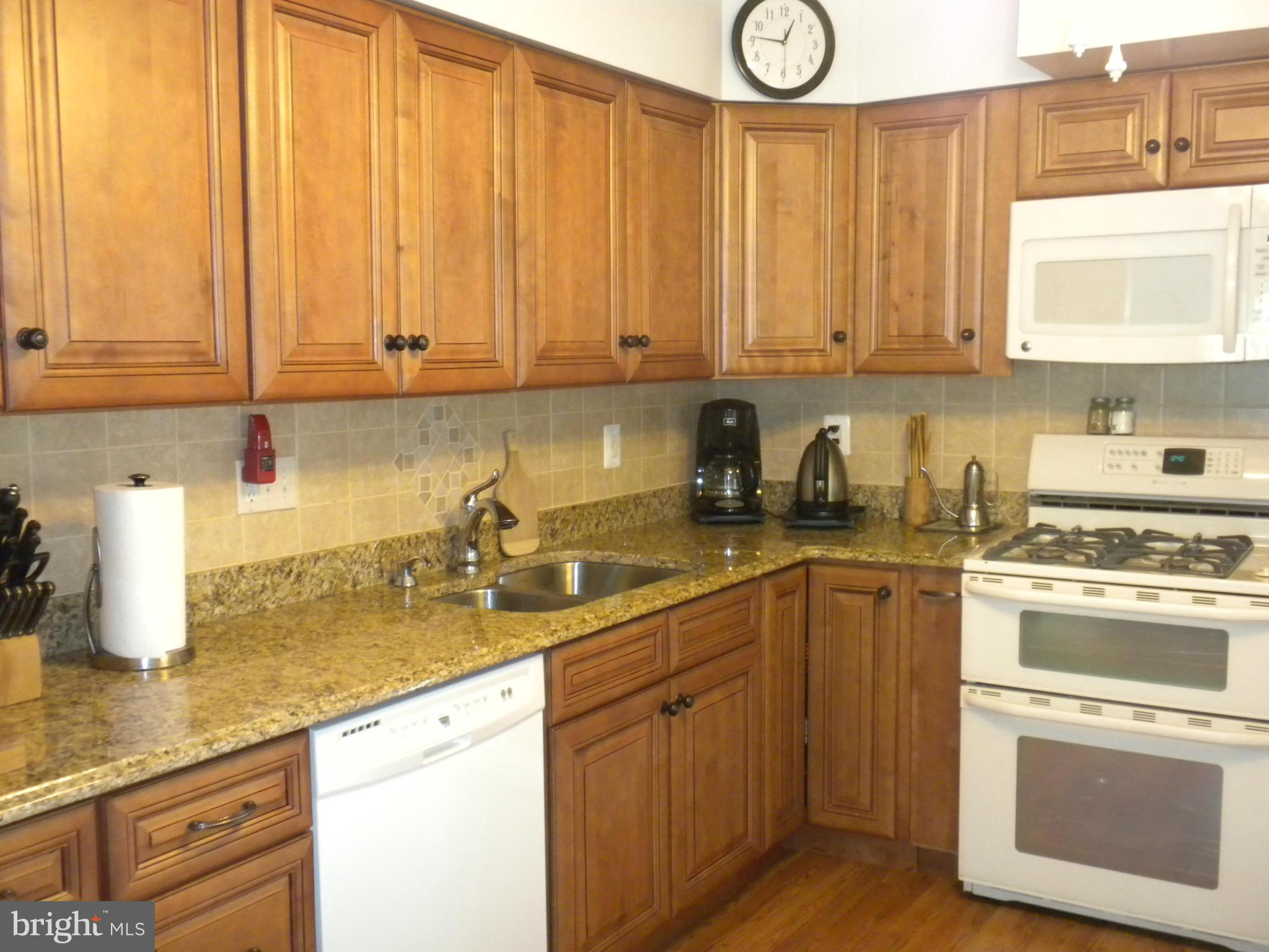 2114 Gaybrook Road Baltimore, MD 21244 - Photo 7 of 19 a kitchen with stainless steel appliances granite countertop a sink a stove and cabinets