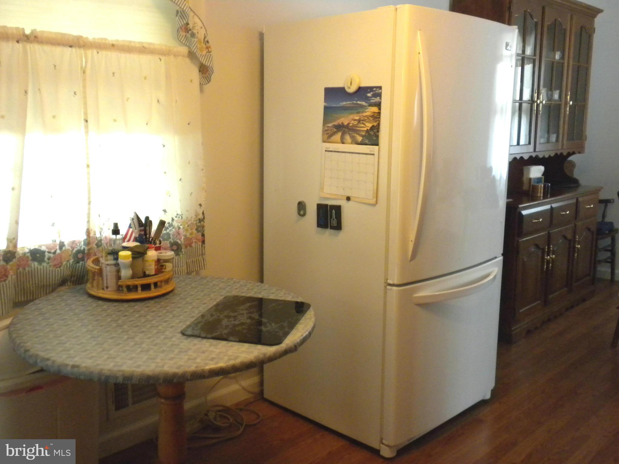 2114 Gaybrook Road Baltimore, MD 21244 - Photo 9 of 19 a kitchen with a refrigerator and table