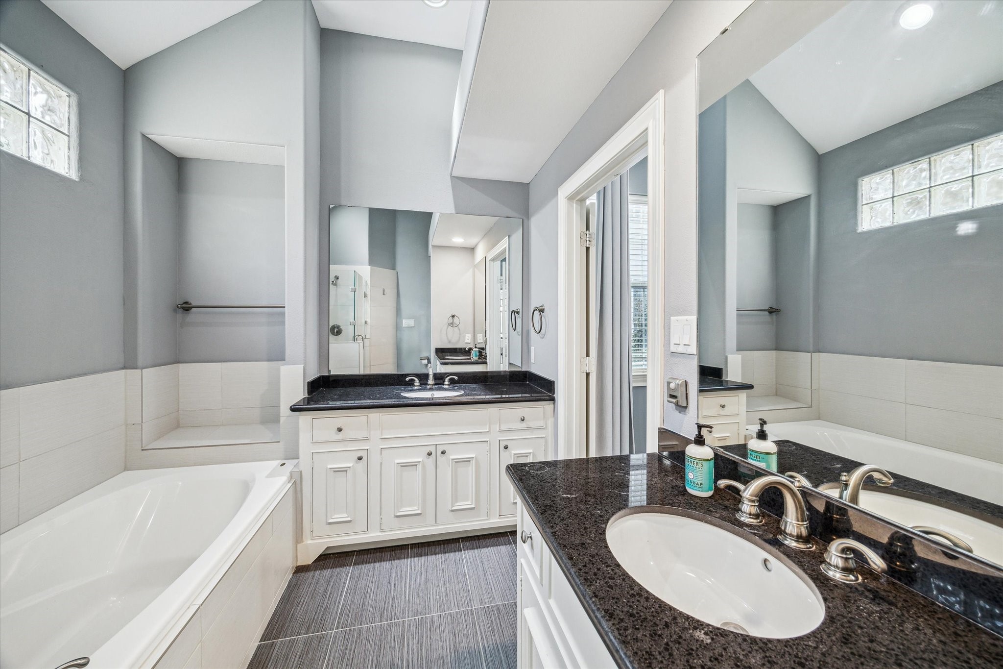 3432 Cline Street Houston, TX 77020 - Photo 9 of 22 a bathroom with a granite countertop tub sink double vanity and mirror
