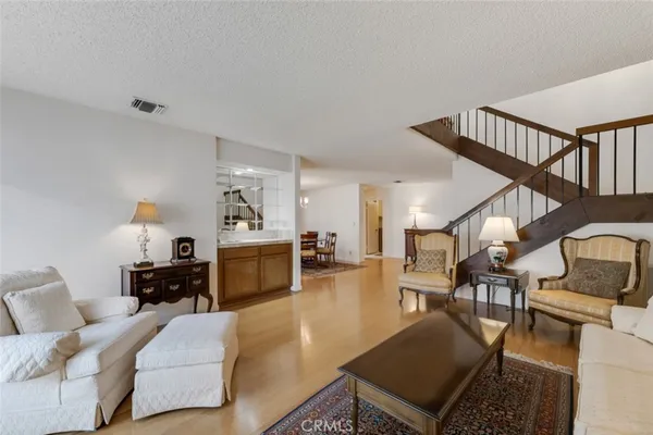 a dining room with furniture a rug and wooden floor