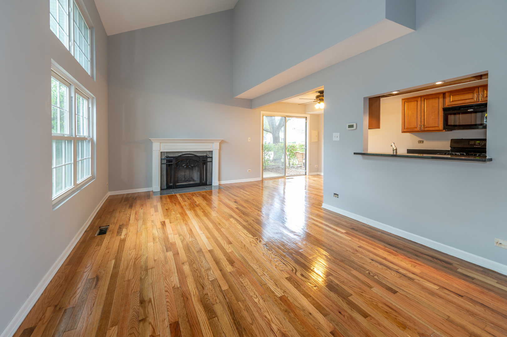 266 Butternut Lane Streamwood, IL 60107 - Photo 2 of 19 a view of empty room with wooden floor and fireplace