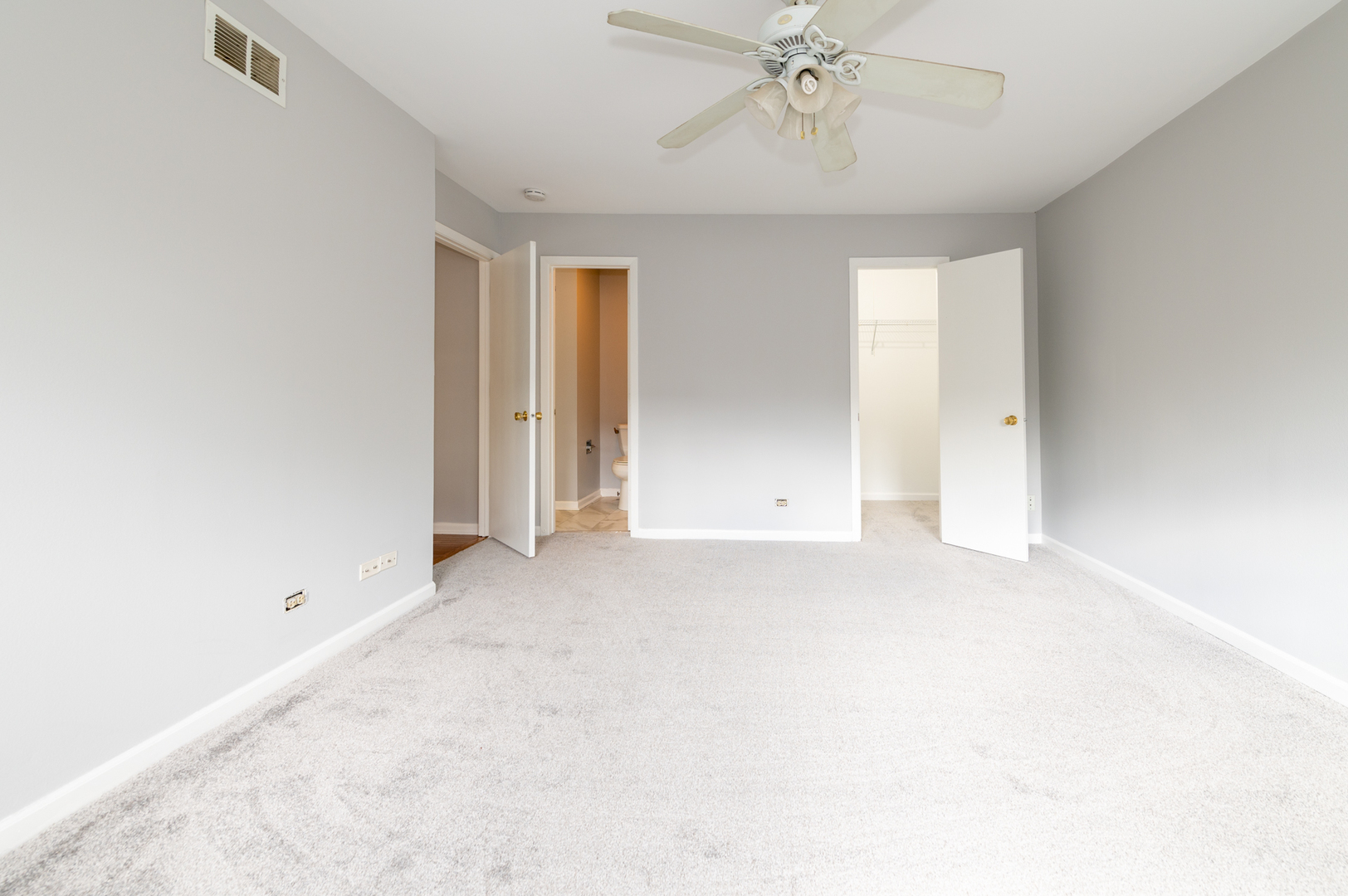 266 Butternut Lane Streamwood, IL 60107 - Photo 13 of 19 an empty room with a chandelier fan and windows