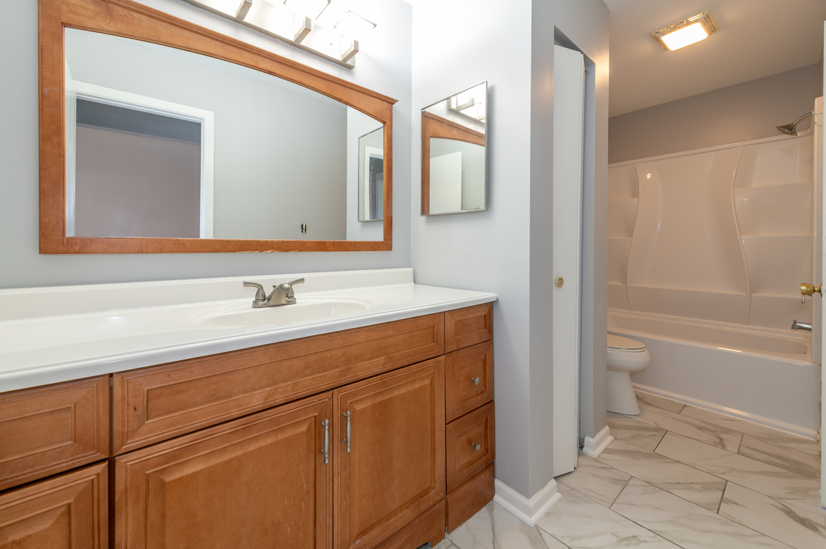 266 Butternut Lane Streamwood, IL 60107 - Photo 15 of 19 a bathroom with a sink and a mirror