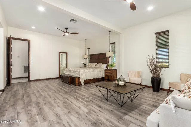 a view of a house with a yard and a large tree