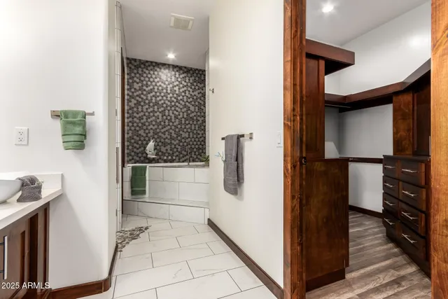 a view of a backyard with table and chairs under an umbrella
