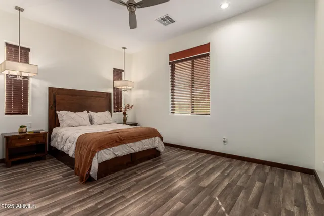a bathroom with a granite countertop sink a toilet and shower