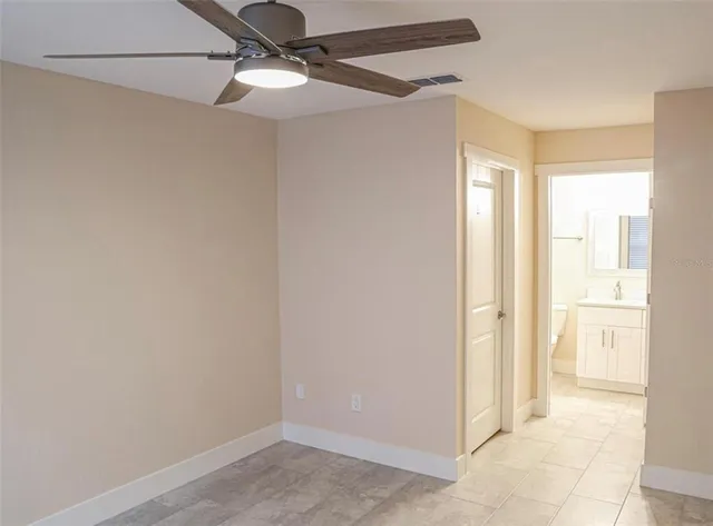 a view of a hallway with a chandelier fan
