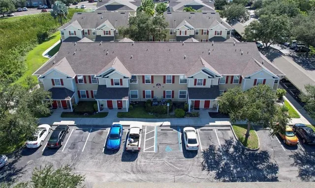 an aerial view of a house with swimming pool and outdoor seating