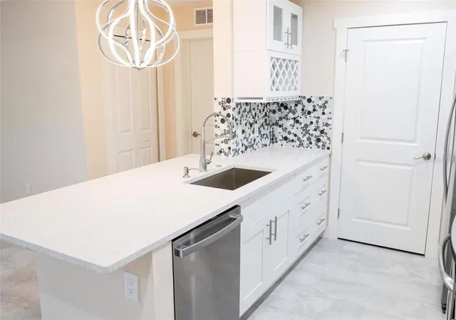 a kitchen with a sink and a refrigerator