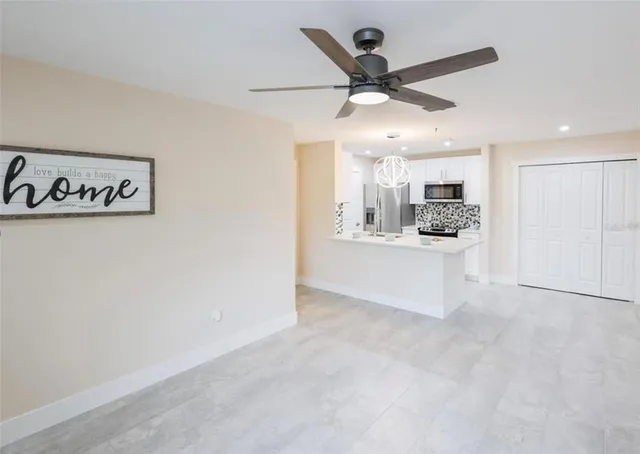 a view of a kitchen with a sink and a refrigerator