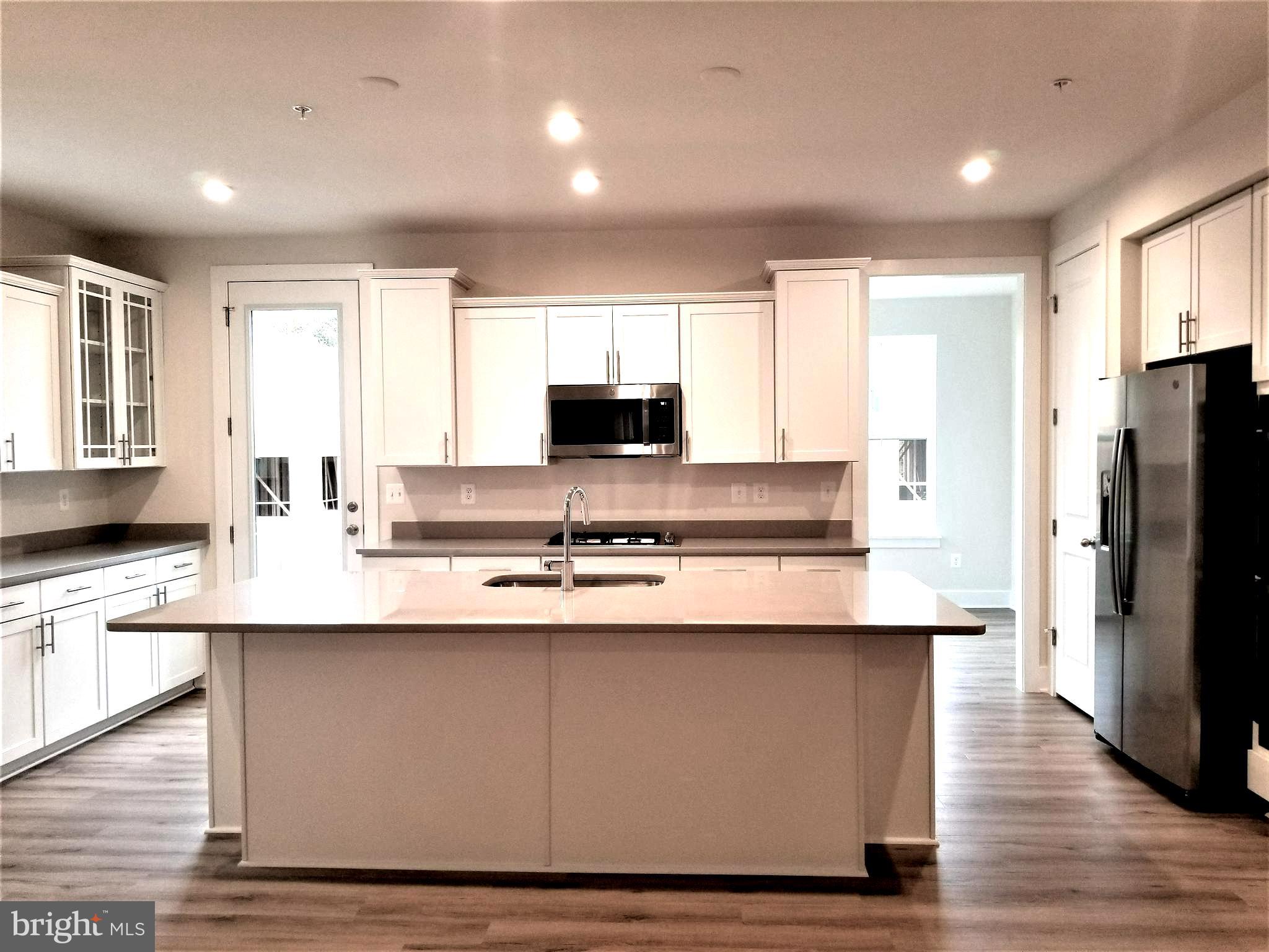 2638 Sequoia Lane Gambrills, MD 21054 - Photo 3 of 14 a large kitchen with stainless steel appliances a sink a stove a refrigerator and cabinets