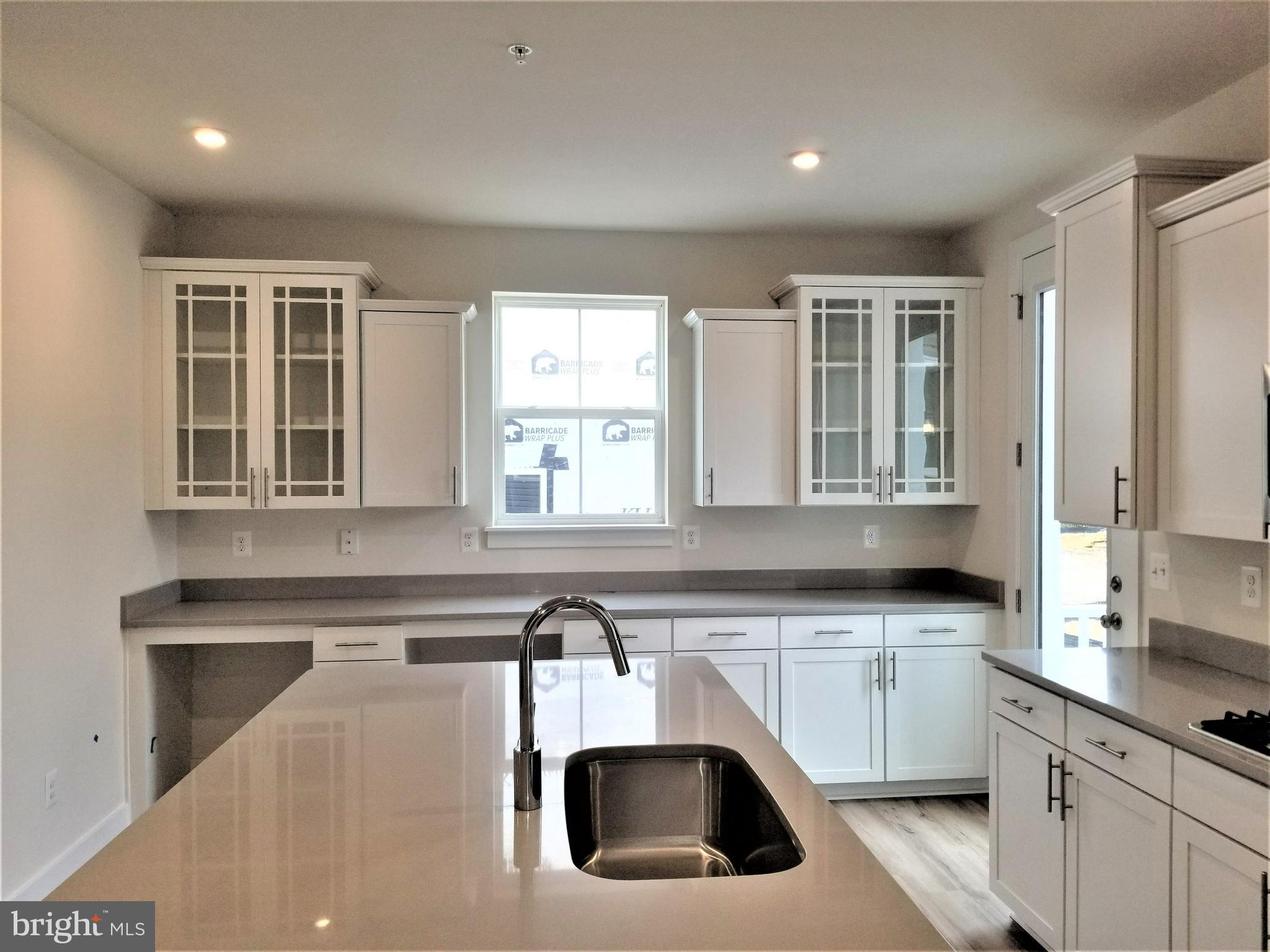 2638 Sequoia Lane Gambrills, MD 21054 - Photo 5 of 14 a kitchen with stainless steel appliances a sink a stove and white cabinets