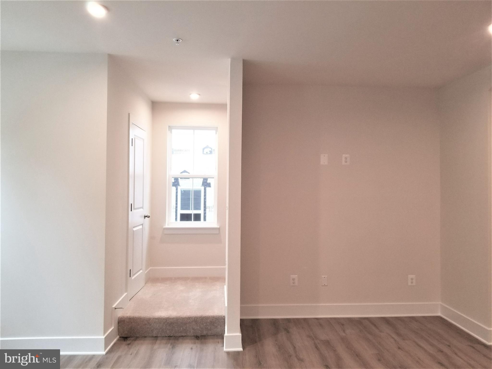 2638 Sequoia Lane Gambrills, MD 21054 - Photo 7 of 14 a view of a hallway with wooden floor and a bathroom