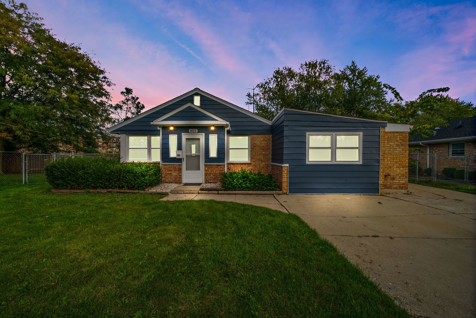 405 Marshall Road Northbrook, IL 60062 - Photo 1 of 27 a front view of a house with a yard and potted plants