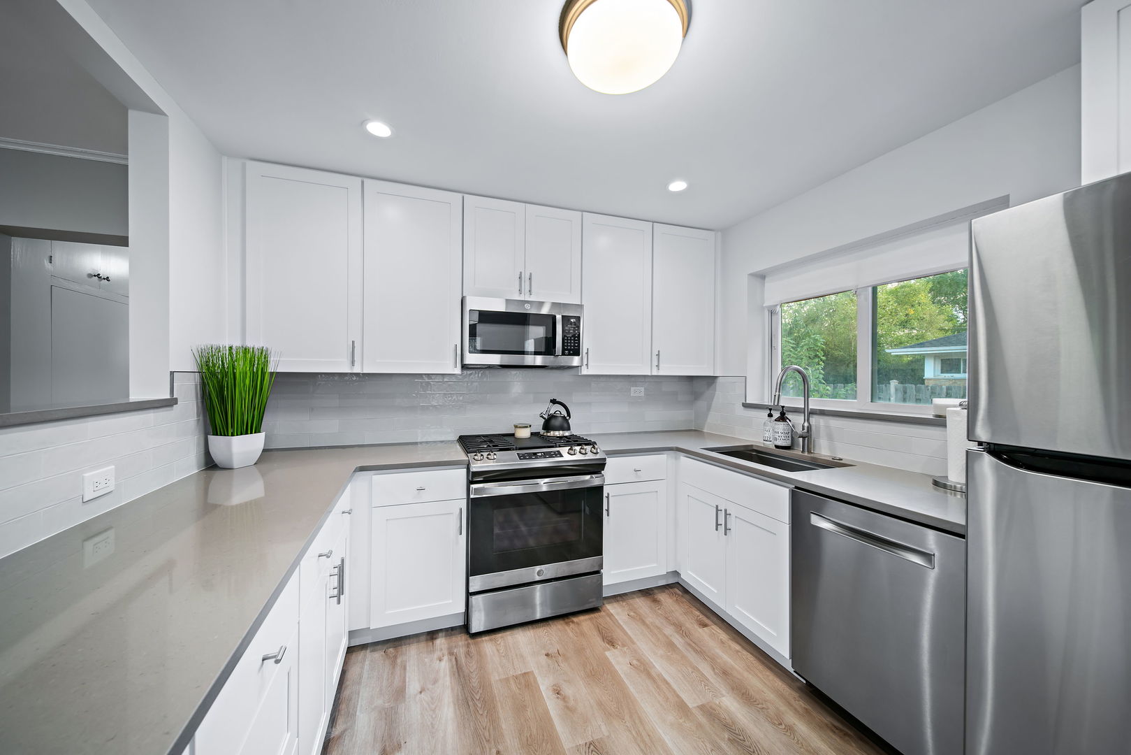 405 Marshall Road Northbrook, IL 60062 - Photo 12 of 27 a kitchen with white cabinets appliances and a window